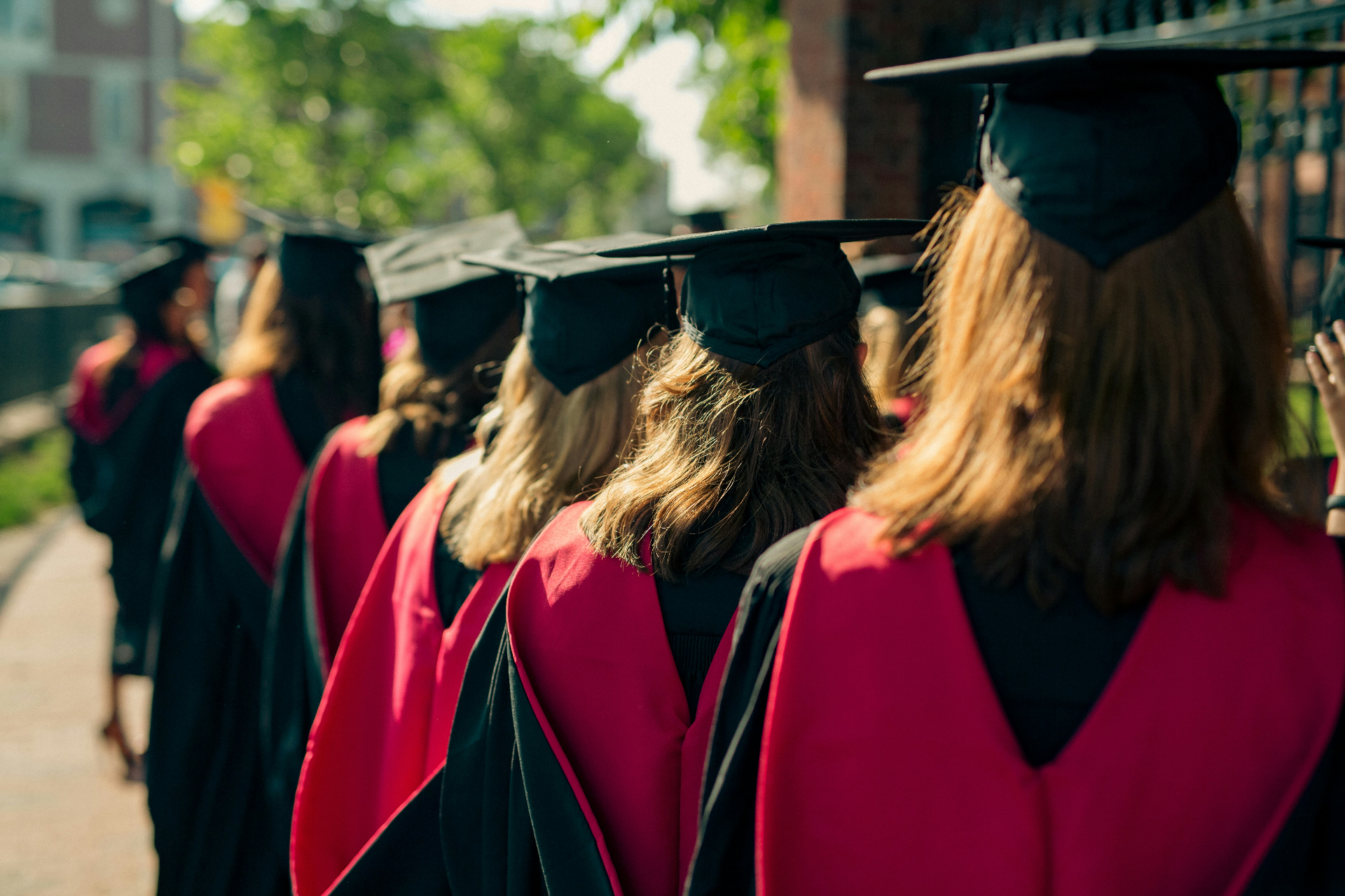 Graduates in caps and gowns walking in a procession